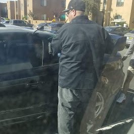 Just In Time Locksmith technician at vehicle during car lockout