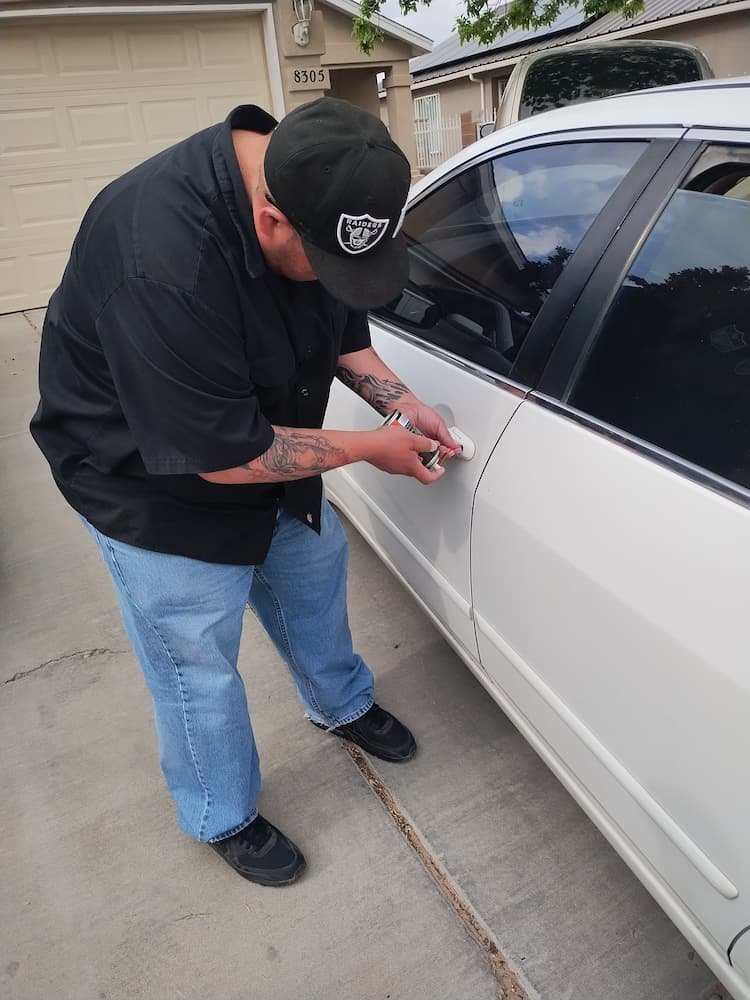 Justin unlocking a white car in Albuquerque